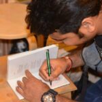 Migrant-Poet-signing-books-at-Call-and-Response_.jpg